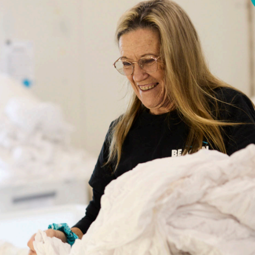 Liz from Beacon Laundry smiling while working